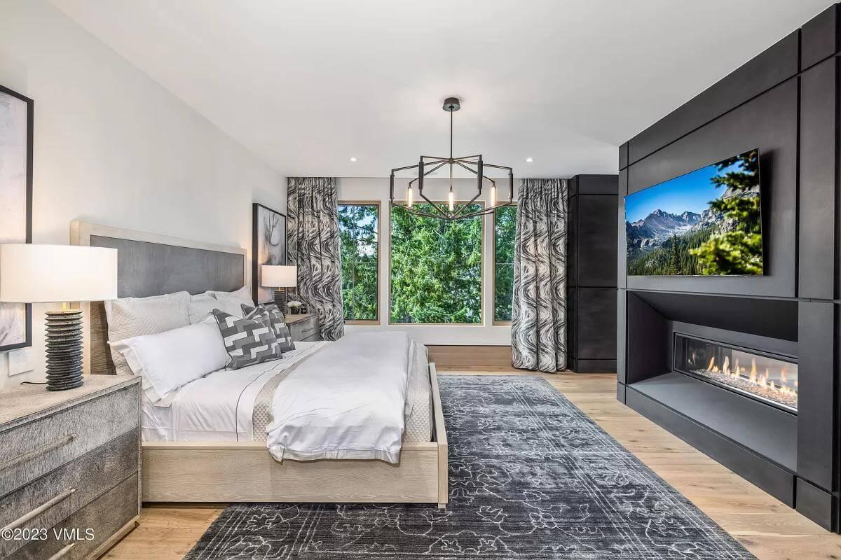 Take In the Fireplace and Mountain Views in This Modern Bedroom