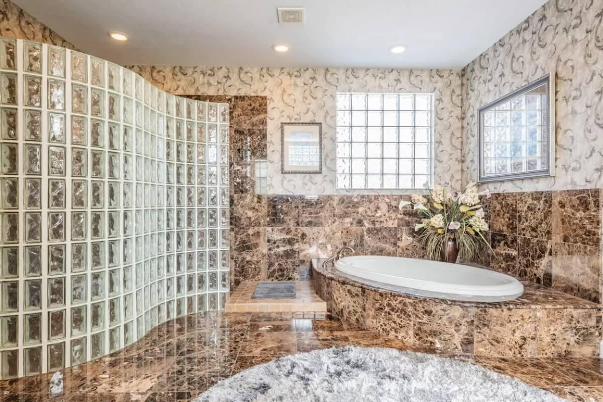 Opulent Bathroom Showcasing Marble and Glass Block Design