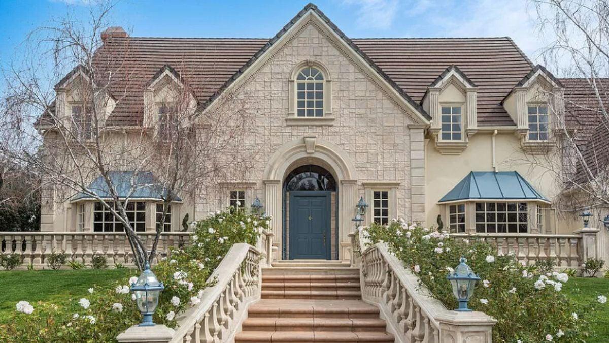 Grand Entry with Elegant Stone Facade and Classic Dormer Windows