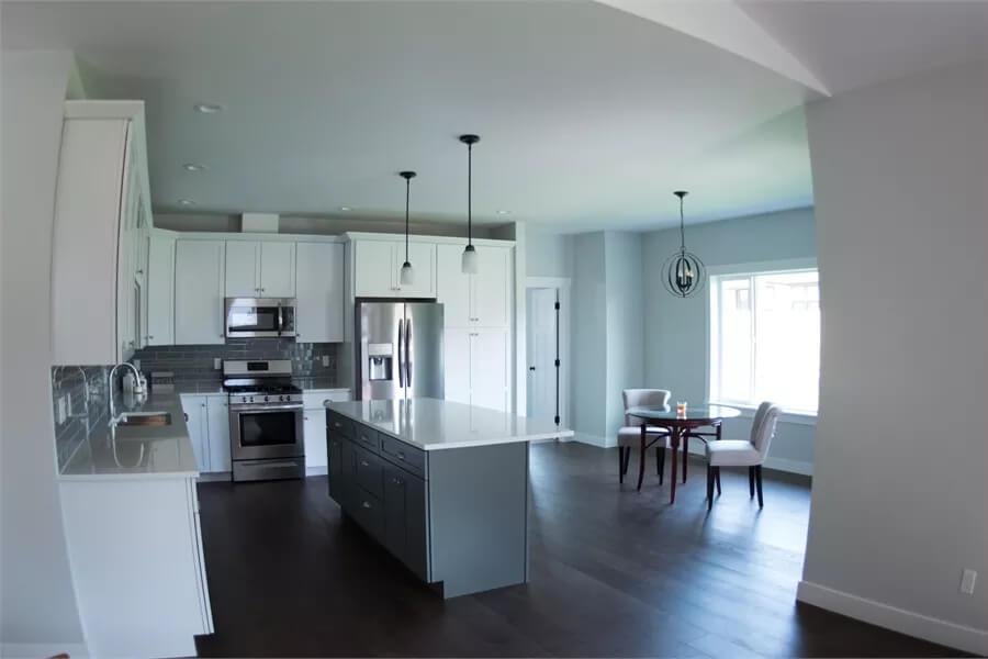 Explore the Gray Backsplash and Dual-Toned Island in This Craftsman Kitchen