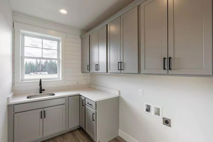 Functional Utility Room With Shiplap Walls and Ample Cabinet Space