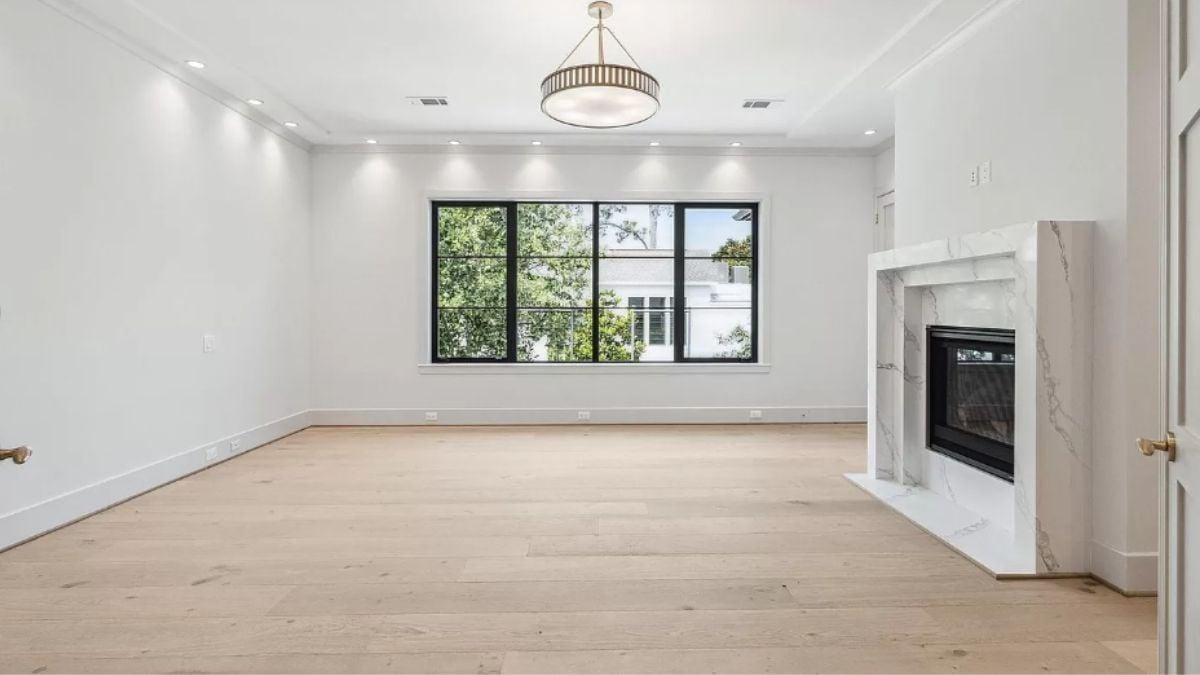 Admire the Sleek Marble Fireplace in This Elegant, Open Space