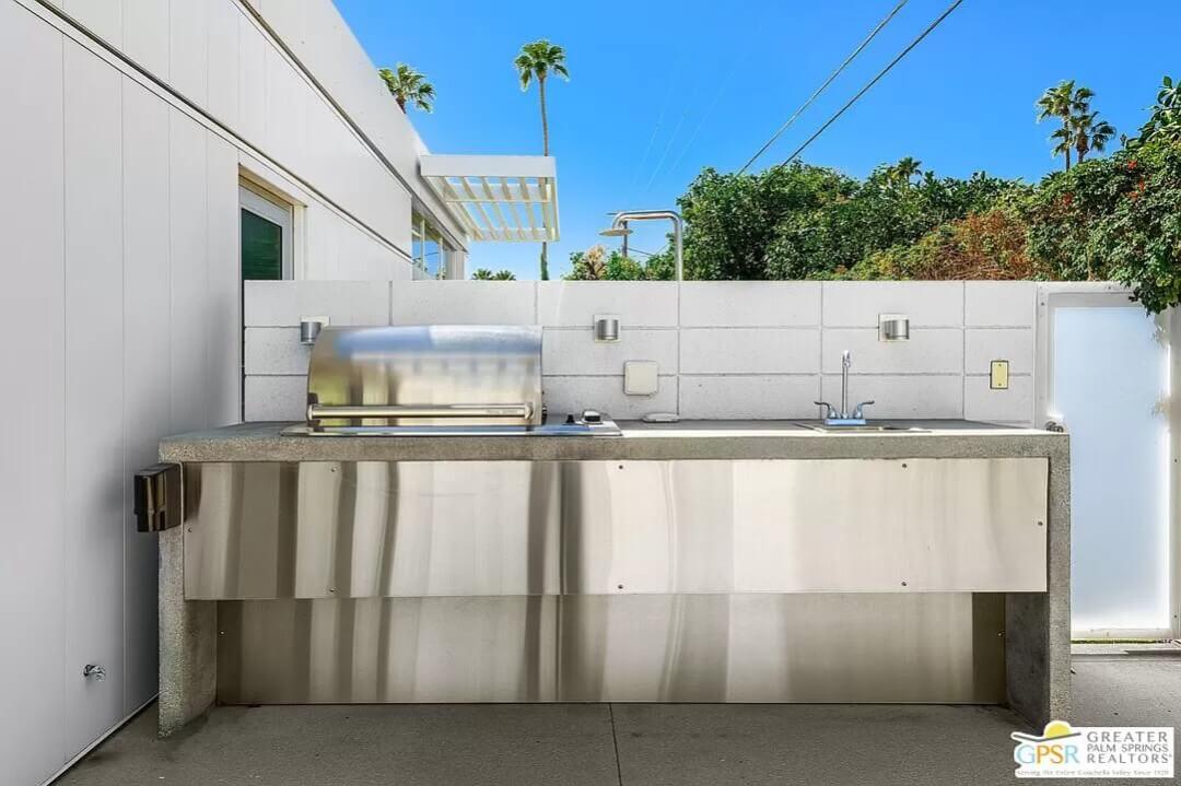 Check Out This Sleek Outdoor Kitchen with Stainless Steel Features