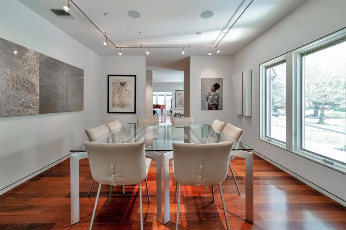 Art Gallery Vibe in This Sleek Dining Room with Glass Table