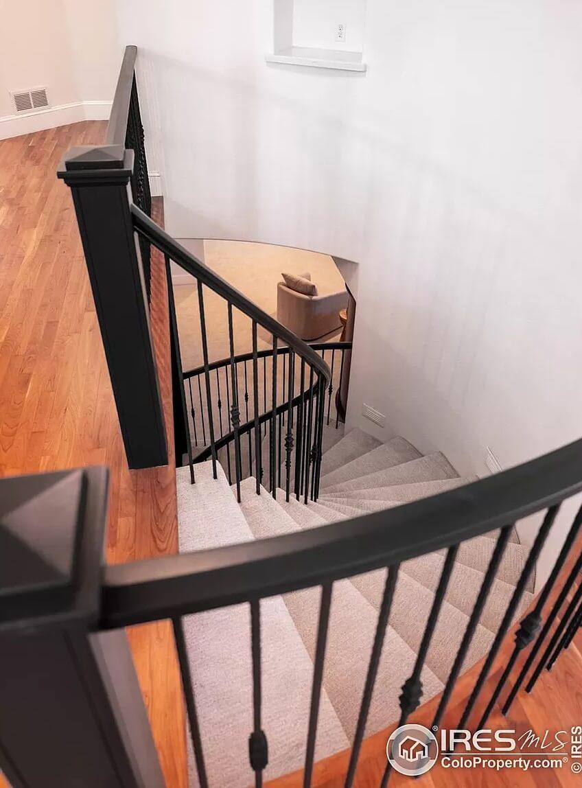 Elegant Curved Staircase with Sleek Iron Railings
