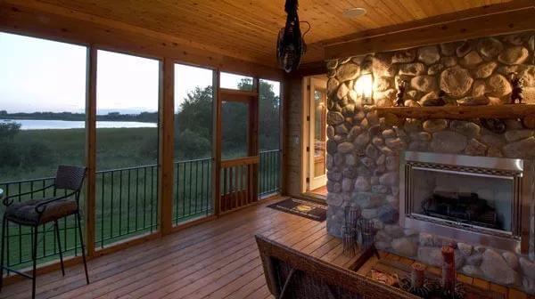 See the Rustic Stone Fireplace on This Cozy Screened Porch