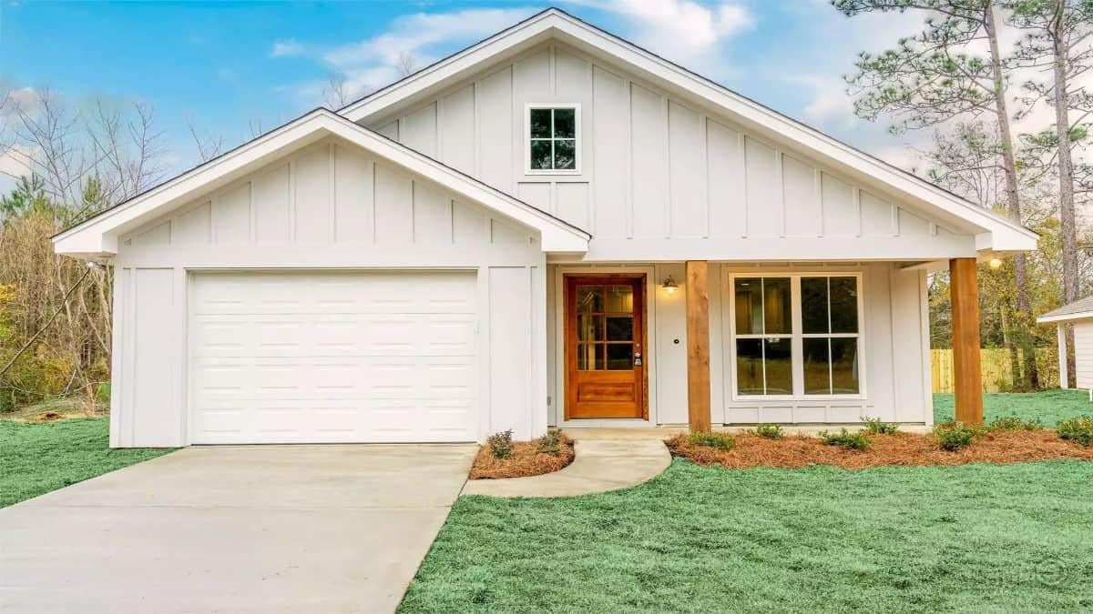 Check Out This Charming White Board-and-Batten Cottage with a Warm Wooden Door