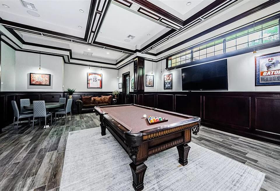 Elegant Game Room with Luxurious Wood Paneling and Billiards Table