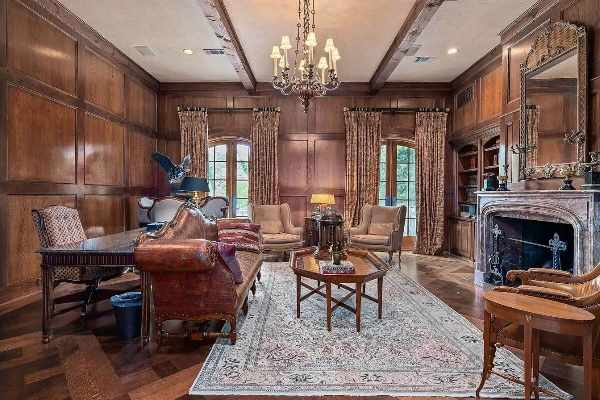 Elegant Library with Rich Wood Paneling and a Cozy Fireplace