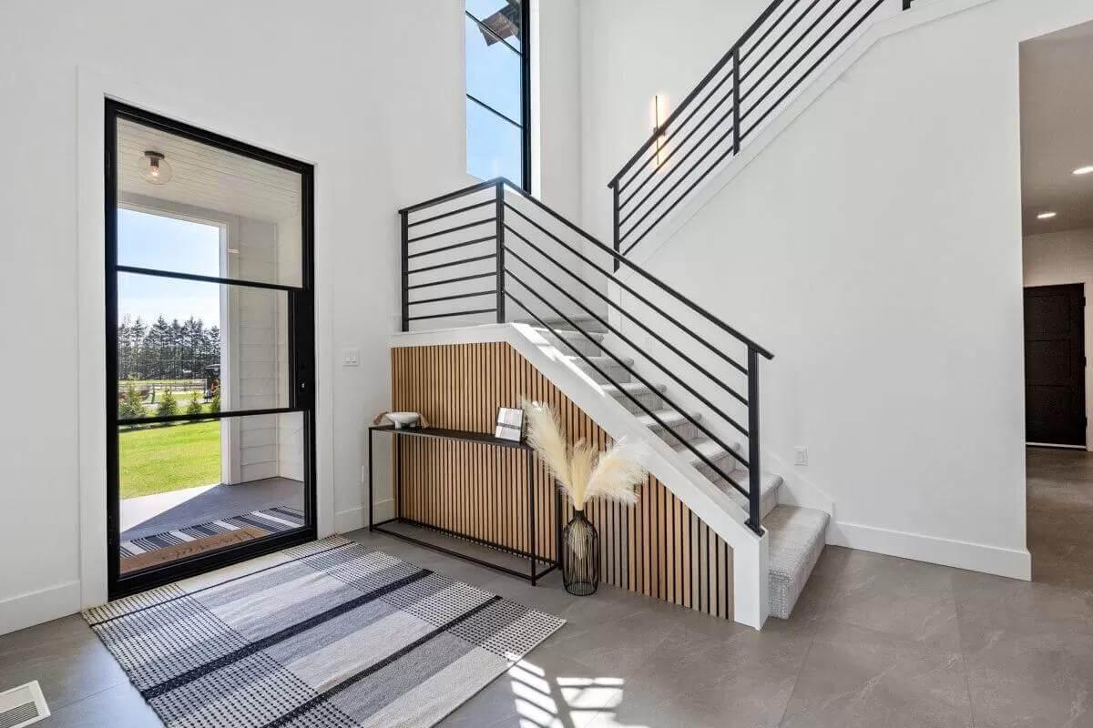 Modern Staircase with Chic Black Railings Enhancing the Entryway
