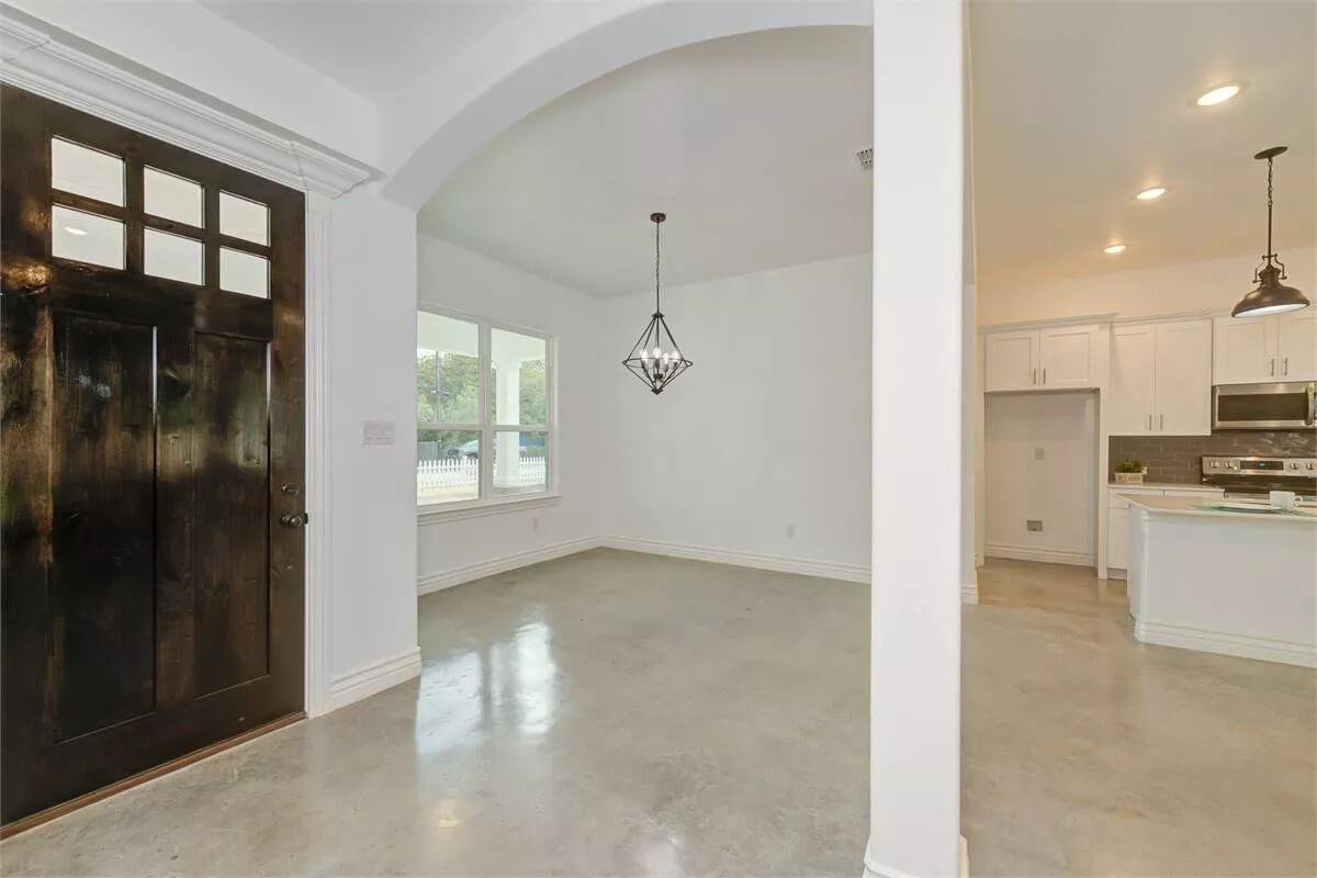 Notice the Intriguing Geometric Light Fixture in This Spacious Foyer