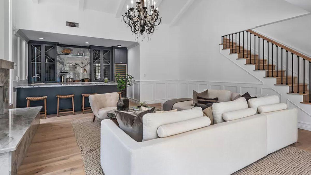 Check Out This Living Area With a Stunning Chandelier and Built-in Bar