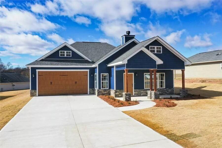 Striking Blue Facade with Stone Accents and Inviting Front Porch