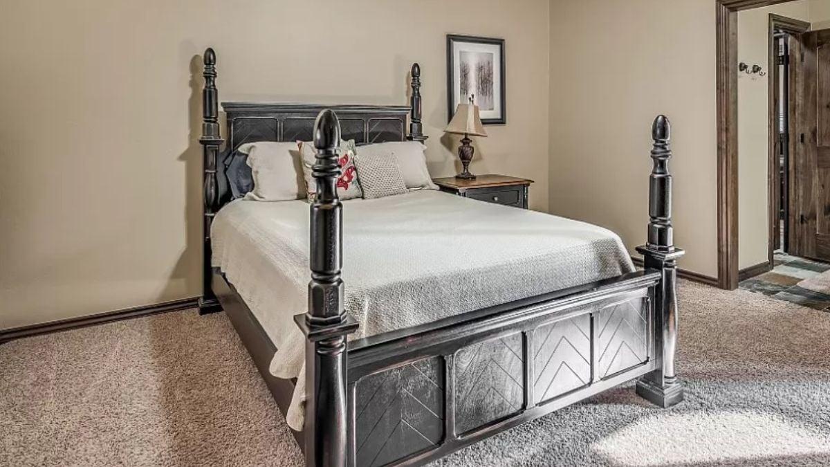 Check Out This Bold Black Wooden Bed Frame Against Soft Neutrals