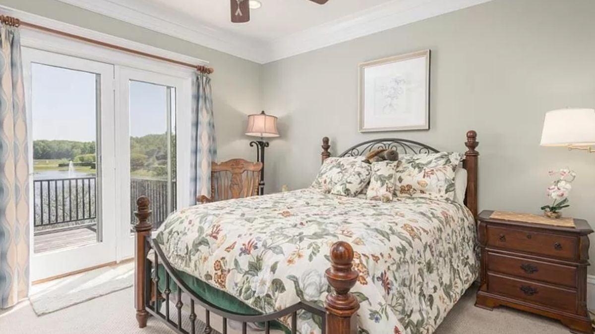 Cozy Bedroom with Floral Bedding and Balcony Views