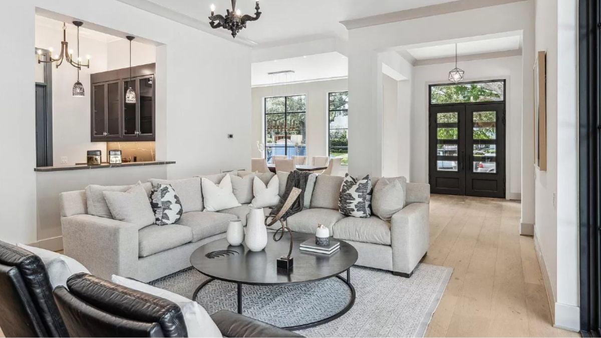 Step Into This Living Room With Its Striking Black Accents and Cozy Seating Area