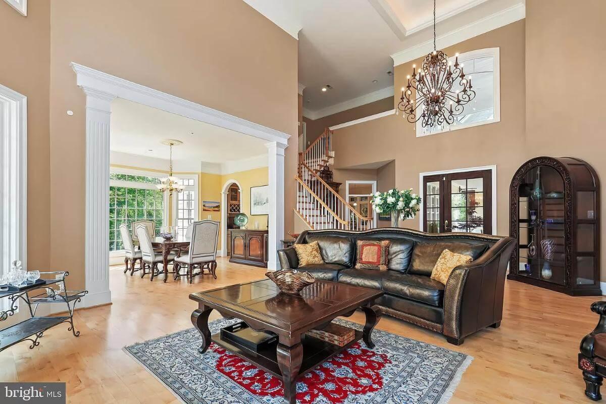 Grand Salon Featuring a Striking Chandelier and Elegant Arched Doorway