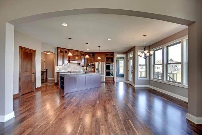 Notice the Archway Leading to This Open-Concept Kitchen with Rich Wood Accents