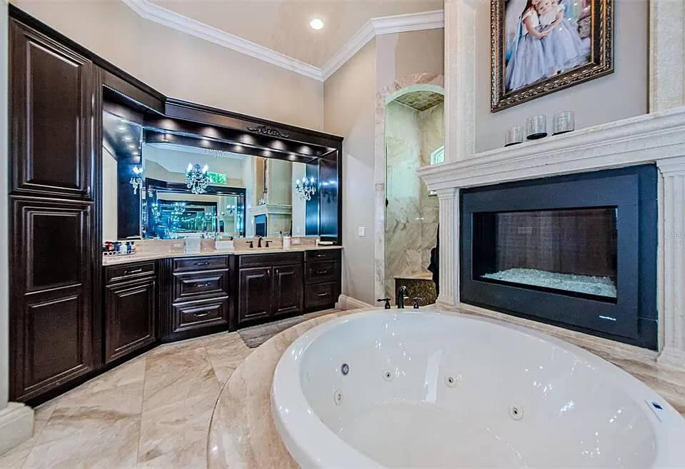 Relax in This Opulent Bathroom with a Double-Sided Fireplace