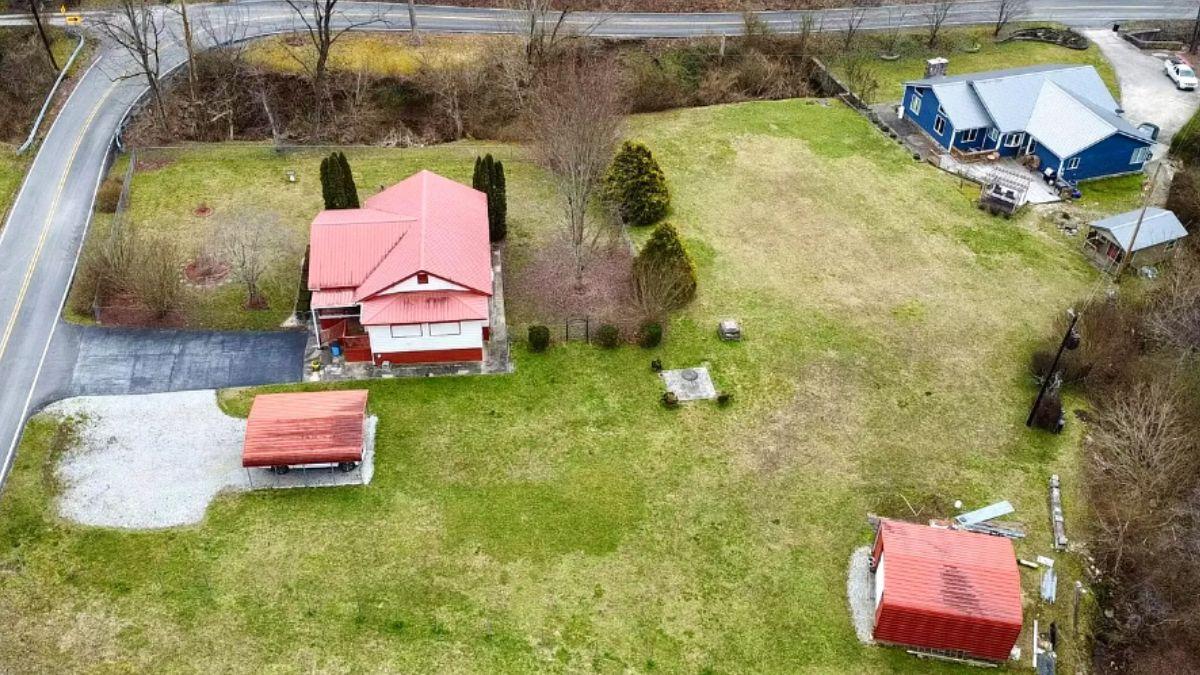 Spot the Bright Red Roof Amidst This Spacious Rural Setting
