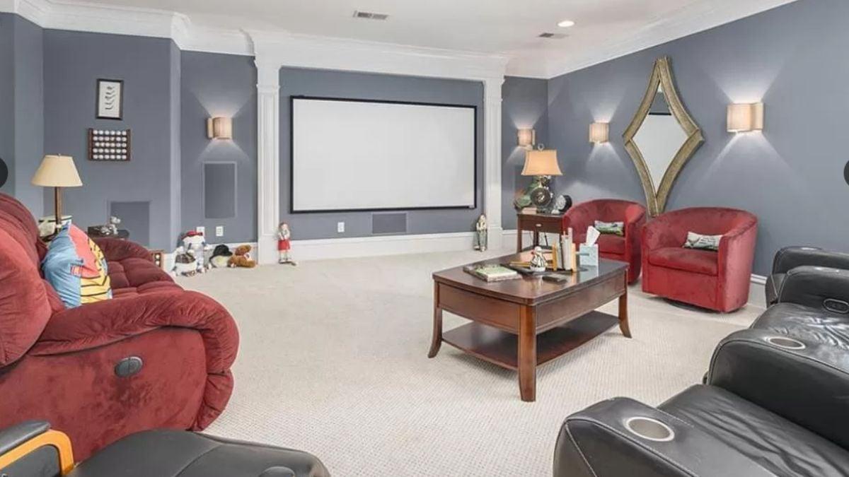 Cozy Media Room With Plush Red Seating and a Home Theater Setup