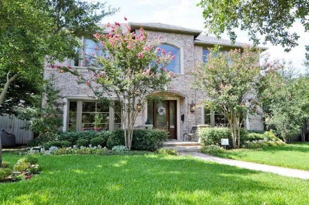 Brick Facade and Lush Greenery Make This Home Stand Out