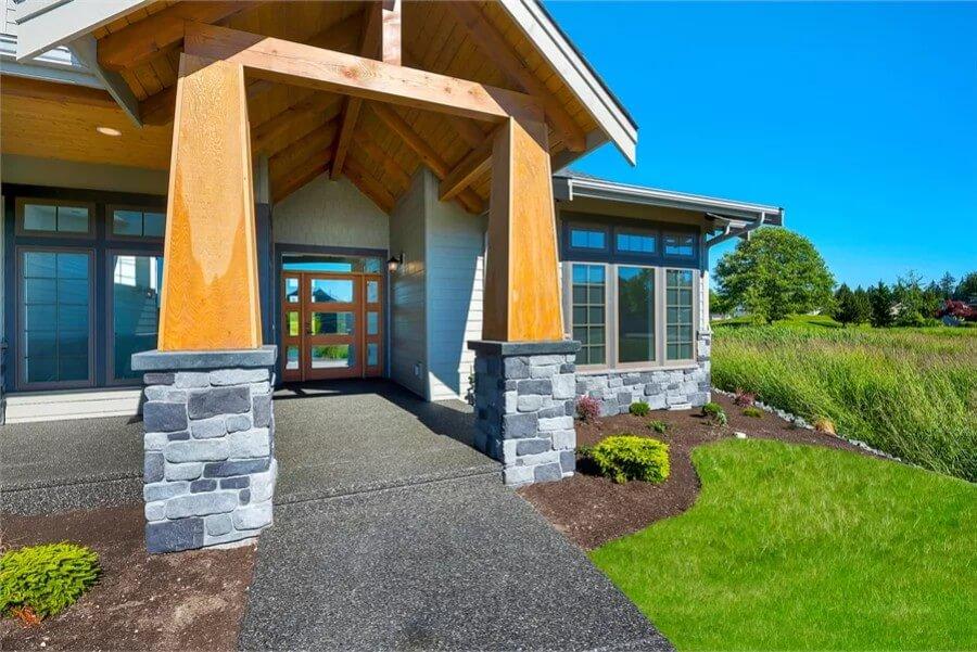Check Out the Robust Timber Entryway Embraced by Stone Pillars