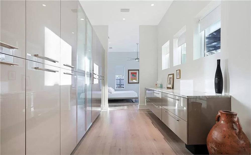 Check Out the Glossy Built-in Wardrobe in This Sleek Hallway