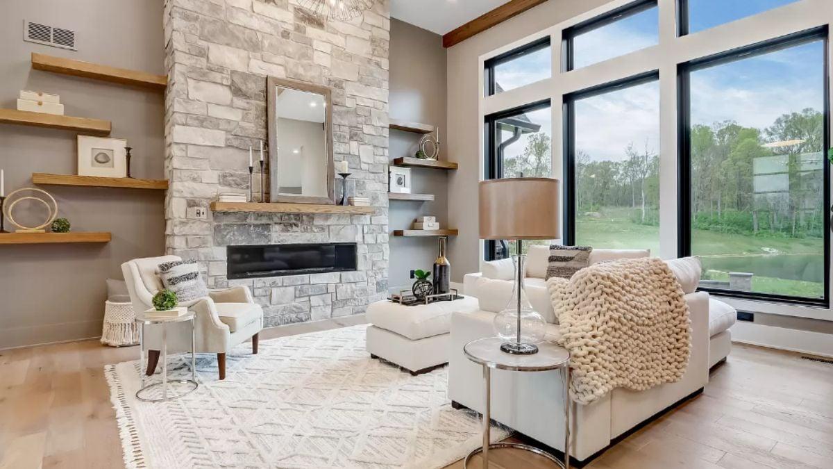 Modern Living Room with a Striking Stone Fireplace and Expansive Windows