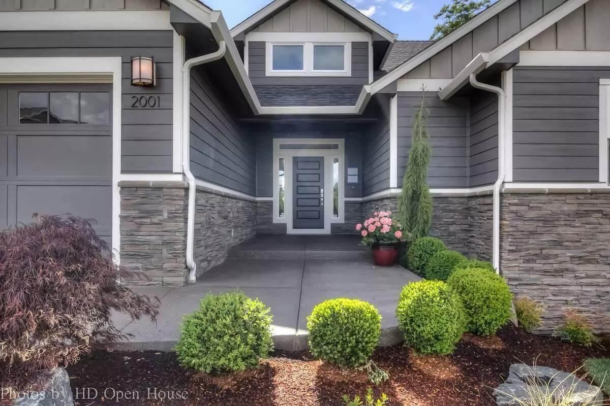 Inviting Front Entrance with Stone Accent Walls and Sleek Door Design