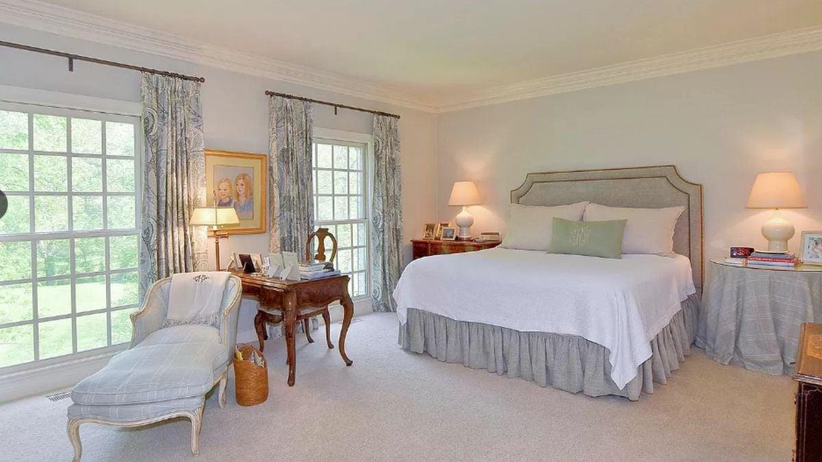 Serene Bedroom with a Vintage Desk and Elegant Draperies