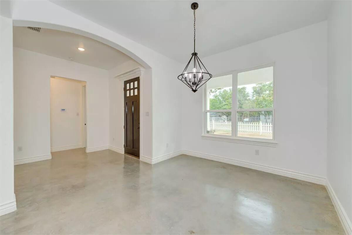 Sleek Minimalist Foyer with Geometric Light Fixture