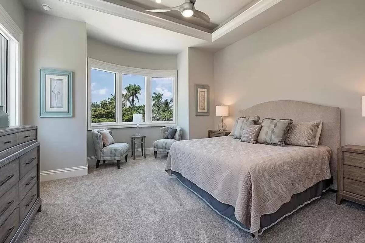 Bedroom with Curved Window Seating Area and Contemporary Fan
