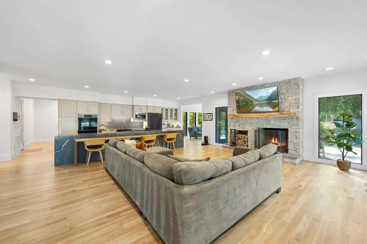 Open-Concept Living Area Featuring a Stone Fireplace Centerpiece