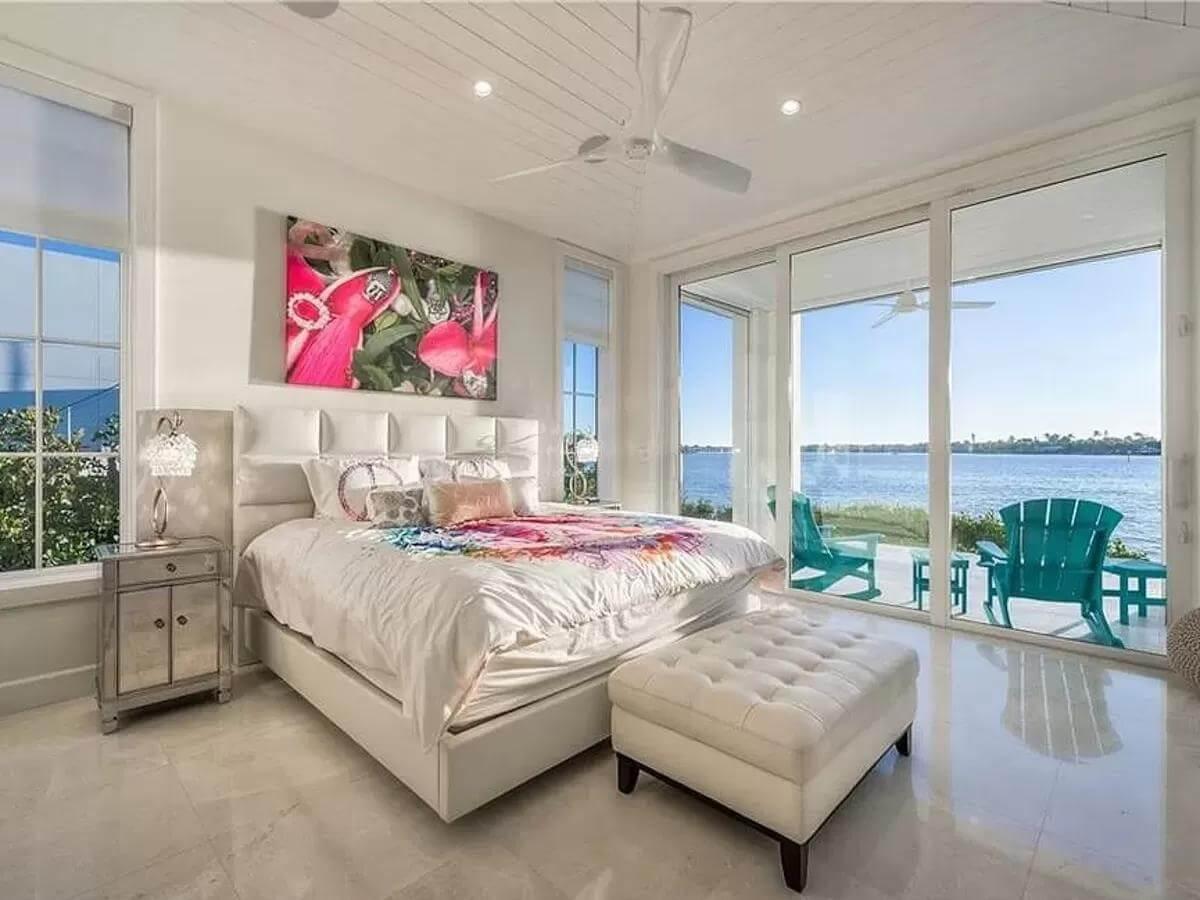 Serene Bedroom with Vibrant Artwork and Waterfront Views