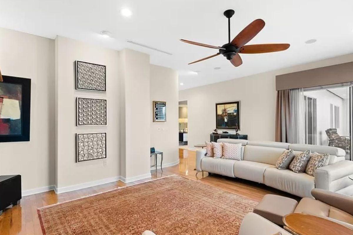 Spot the Warm Wood Accents and Cozy Rug in This Modern Living Space