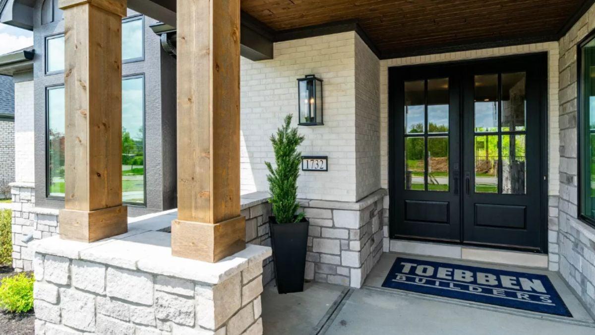 Take Note of the Bold Black Entryway Paired with Stone Accents