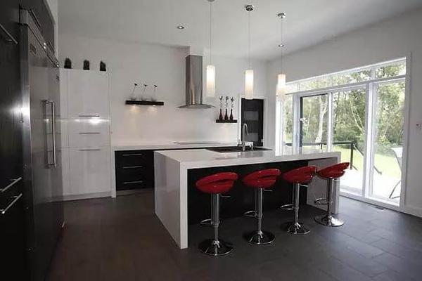 Striking Red Bar Stools Add a Pop of Color to this Sleek Kitchen