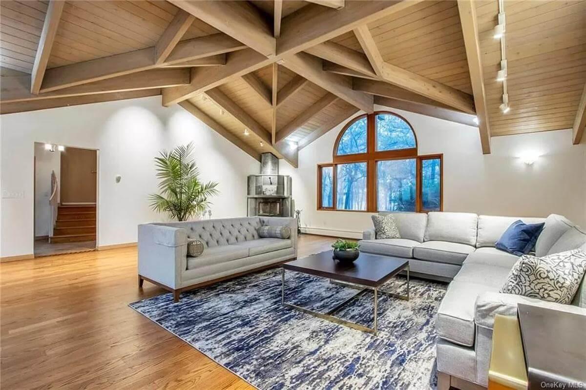 Look at Those Stunning Exposed Beams in This Spacious Living Area