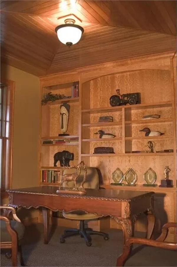 Elegant Study with Intricate Wood Paneling and Built-in Shelving