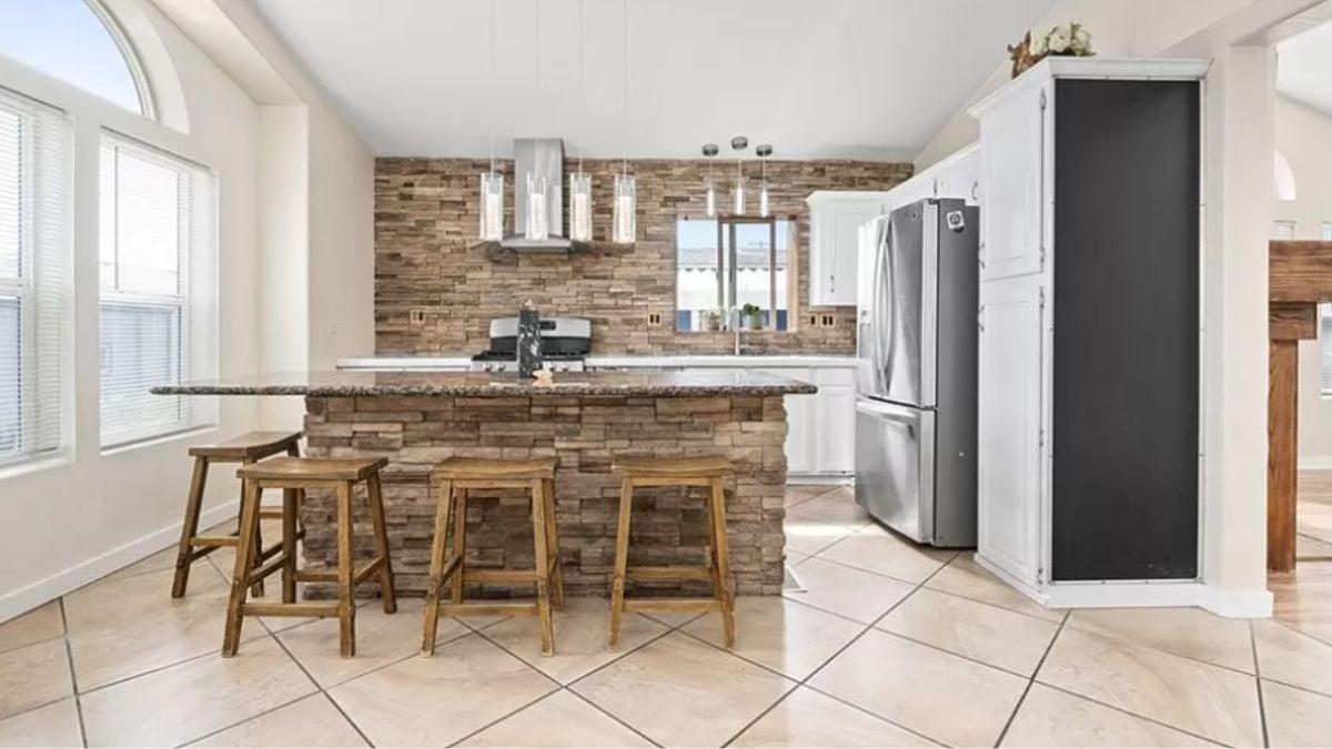 Rustic Charm with a Stone-Front Island Setting the Scene
