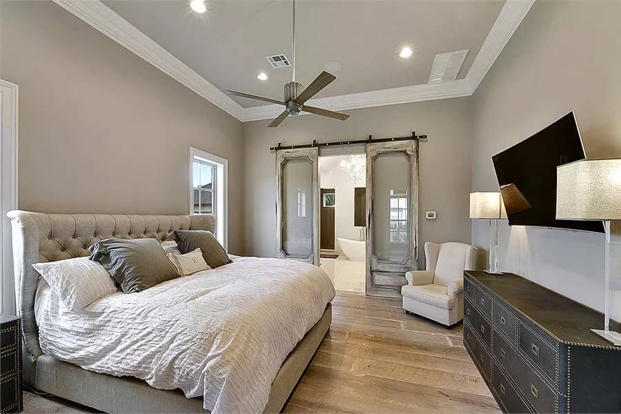 Check Out the Vintage-Inspired Barn Doors in This Elegant Bedroom