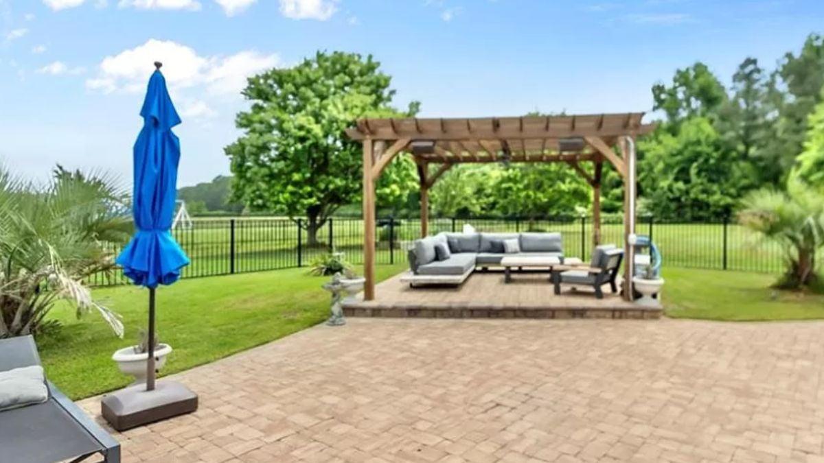 Relax Under the Pergola in This Open Backyard Lounge