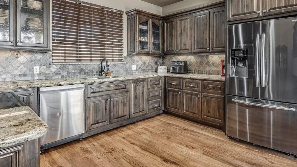 Rustic Wood Cabinets with a Textured Stone Backsplash—Kitchen Comforts