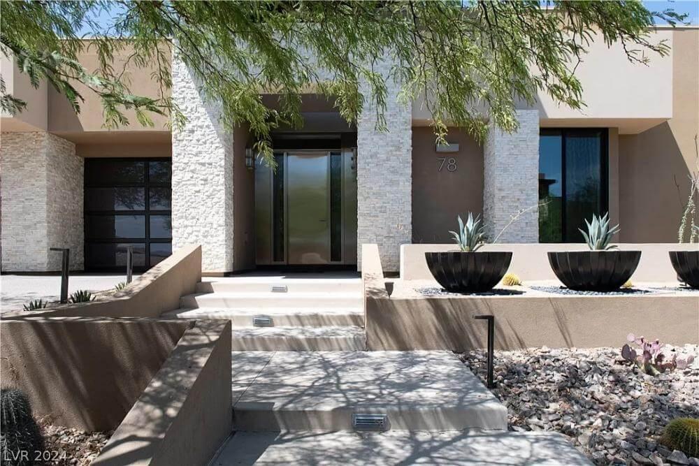 Check Out the Sleek Entryway Framed by Unique Planters