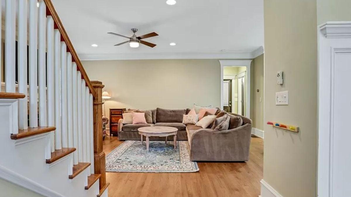 Cozy Living Room with a Comfy Sectional and Eye-Catching Staircase