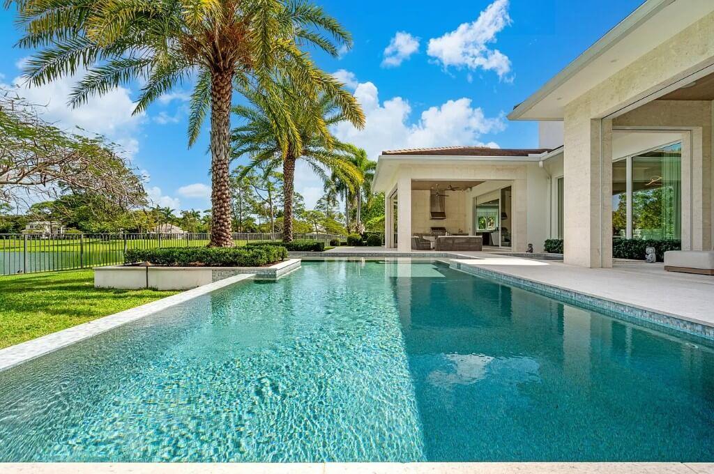 Dive Into This Exquisite Pool with a Tropical Backdrop
