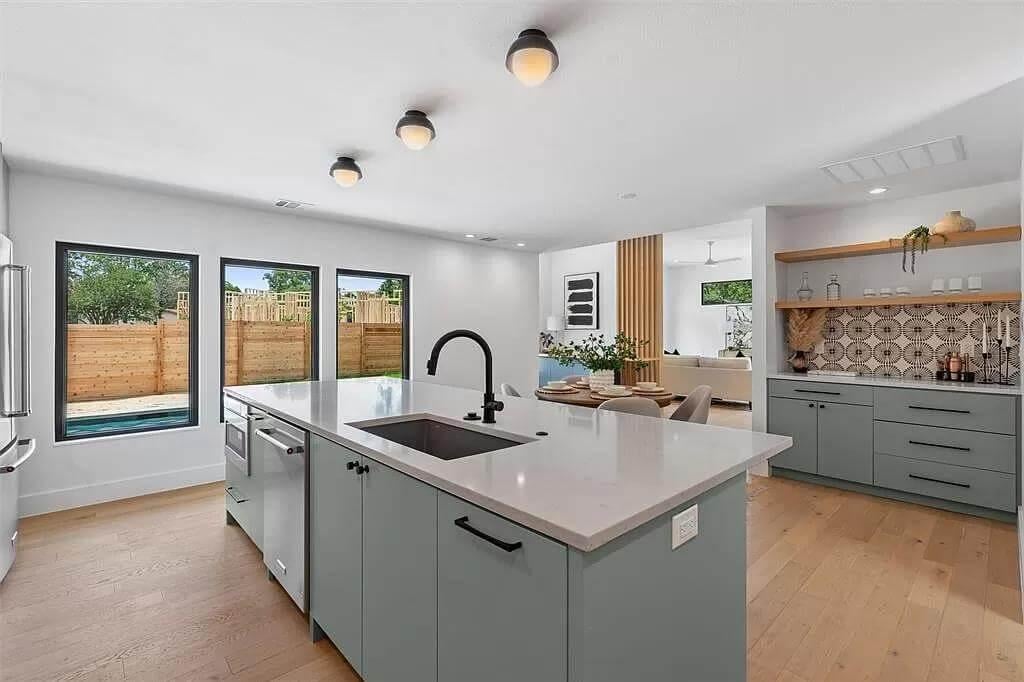 Sleek Kitchen with Open Shelving and Expansive Island