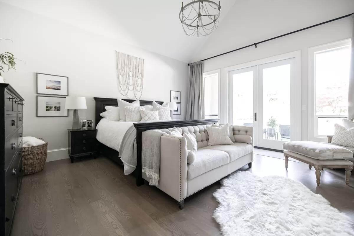 Elegant Bedroom with a Tufted Sofa and Vaulted Ceilings