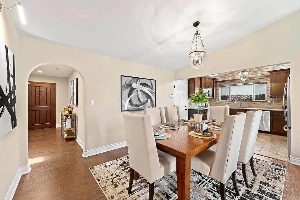 Elegant Dining Room with a Touch of Modern ArtโNotice the Arched Entryway